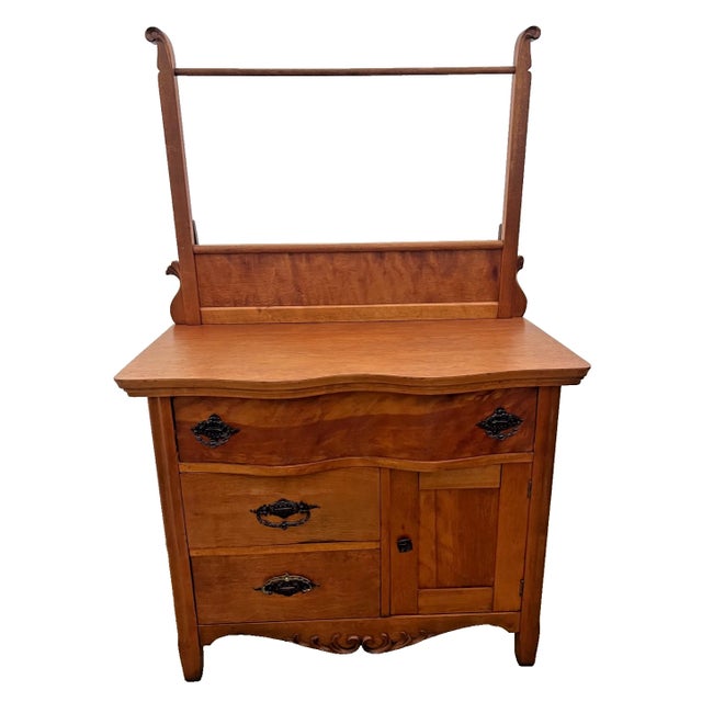 Maximize your storage and historic style with this rare solid cherry antique washstand featuring three drawers, a side...