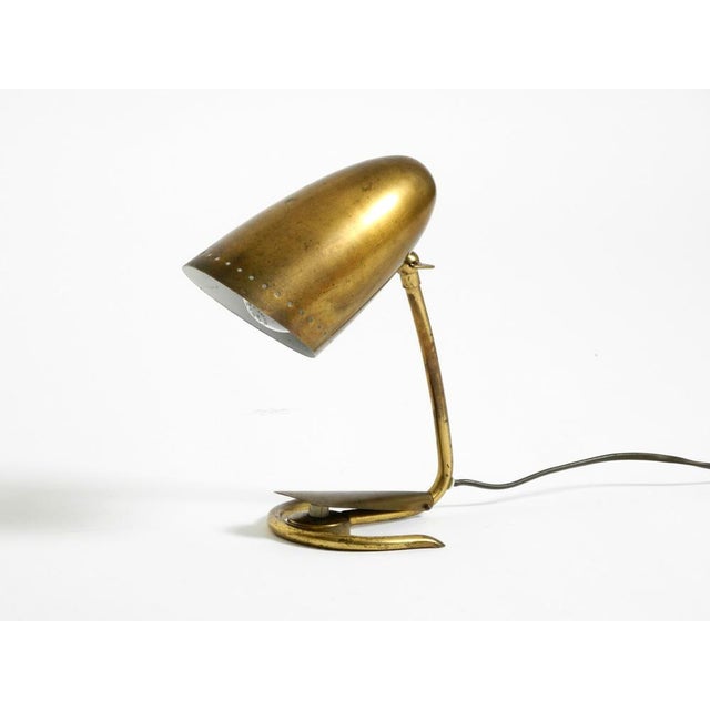 Very rare and extraordinary Mid-Century Modern brass table lamp. Beautiful 1950s design in good vintage condition. The...