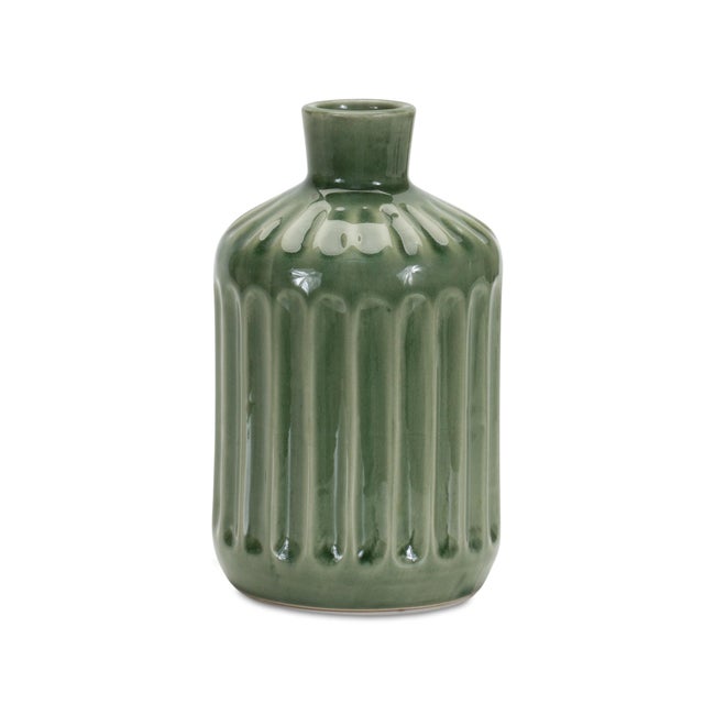 Add a touch of nature to your living space with the Green Ribbed Terra Cotta Vase. Standing at 7" tall, this vase features...