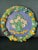 A large vintage Italian majolica wall charger in the Della Robbia revival style. The rim features a dense, raised garland...