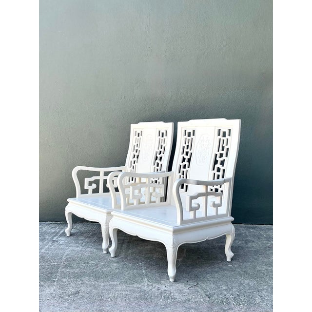 Elevate your seating arrangement with this exquisite pair of vintage white lacquered lounge chairs, a masterclass in...
