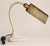 Vintage industrial gooseneck task lamp featuring a cream-painted metal base, flexible gooseneck arm, and pivoting brass...