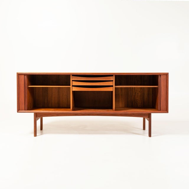 A classic Mid Century Modern Danish Credenza with Tambour door, manufactured by Bernhard Pedersen & Son. In great vintage...