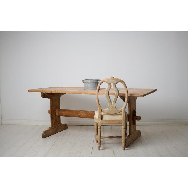 Antique Swedish dining table or work table from the 1840s. Trestle table made by hand in solid pine in northern Sweden....