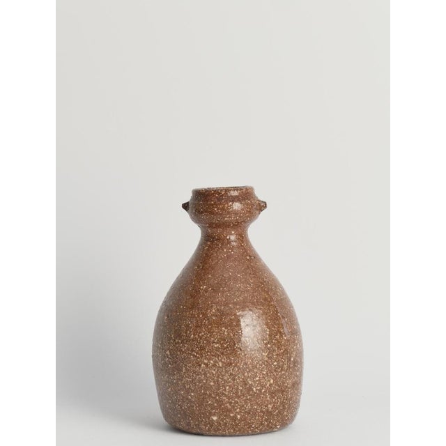 This exquisite handmade stoneware vase is reminiscent of the famed Japanese Shigaraki pottery tradition, renowned for its...