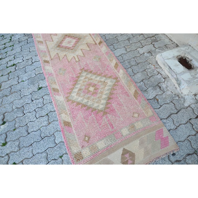 This is a vintage Turkish Oushak rug from the 1960s. The piece was hand-knotted.