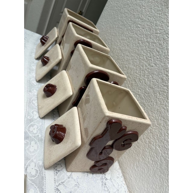 Vintage handcrafted, pottery, ceramic textural, and groovy kitchen canisters. Set of four with bold whimsical labeling...