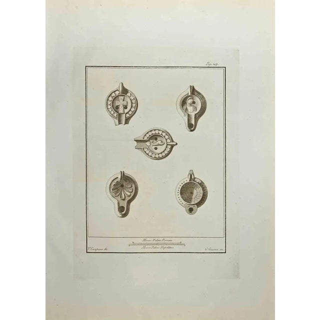 Still Life from "Antiquities of Herculaneum" is an etching on paper realized by Giovanni Guerra in the 18th Century....