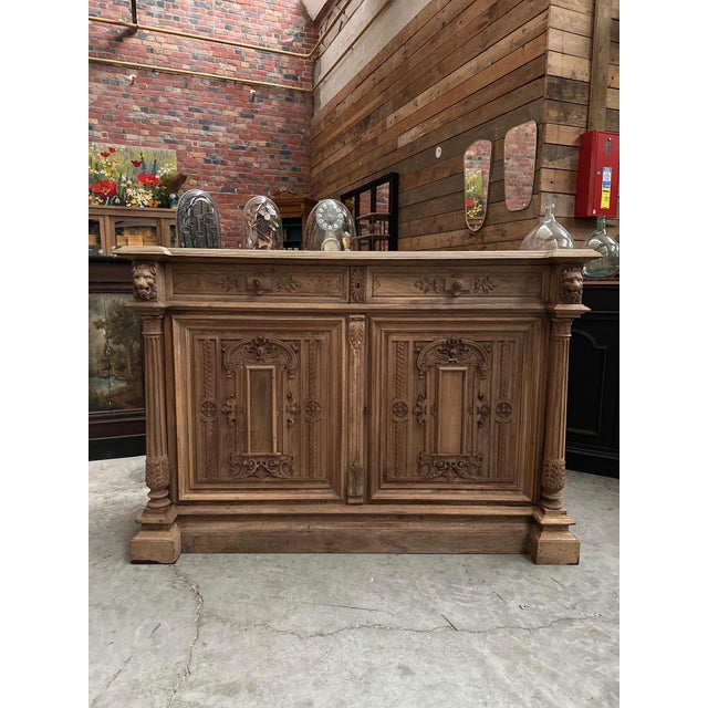 This antique walnut castle sideboard has been fully restored. Its carved wooden front is decorated with floral motifs,...
