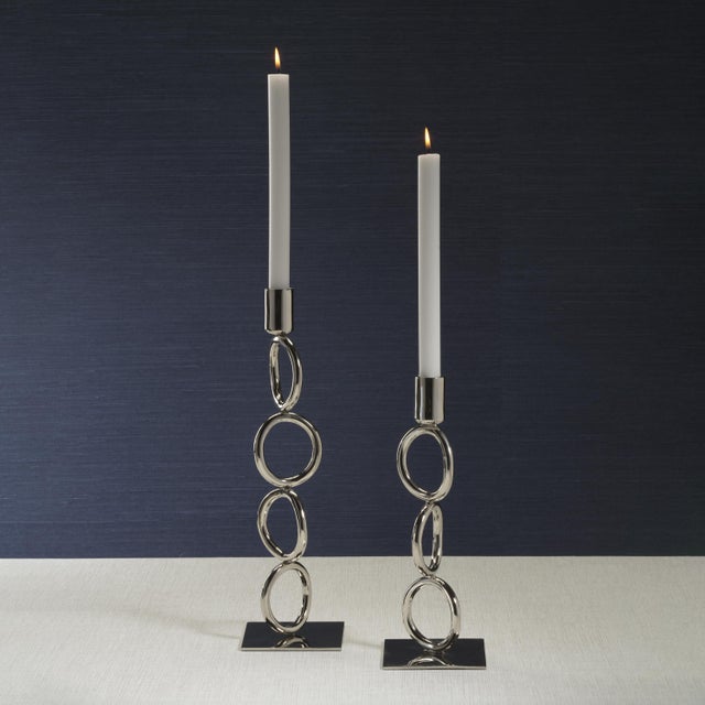 A striking blend of geometry and elegance, this stainless steel candle holder features a polished nickel finish and a...