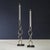 A striking blend of geometry and elegance, this stainless steel candle holder features a polished nickel finish and a...