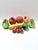 A colorful collection of vintage beaded and sequined decorative fruit, including apples, pears, cherries, citrus, and a...
