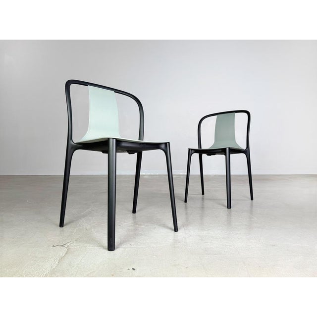 Set of 2 Vitra Belleville stacking chairs in the color moss gray. The chairs are made entirely of plastic and are...