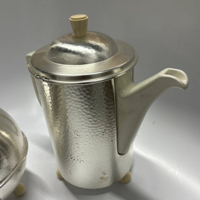 Beautiful Vintage Art Deco insulated VMF/HUTSCHENREUTHER tea and coffee pots. Pots are made of porcelain with a hammered...