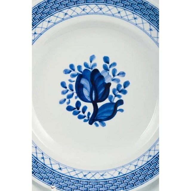 14 plates, model number 11/1842. Aluminia, Tranquebar. Light blue faience with dark blue tulip and braided border,...