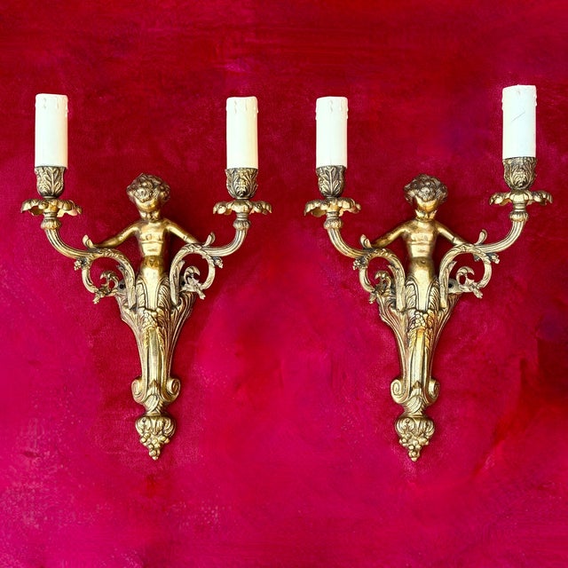 A pair of french wall sconces dating to circa 1930, executed in the louis xv / rococo revival style. Each piece features a...