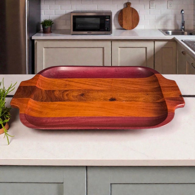 This vintage mid-century modern mixed wood serving tray is a stylish addition to any home. The rectangular shape and brown...