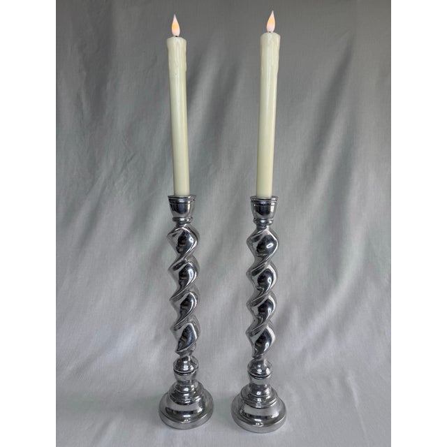 This pair of vintage candlesticks feature a striking barley twist stem that mimics a classic-open-helix design. The silver...