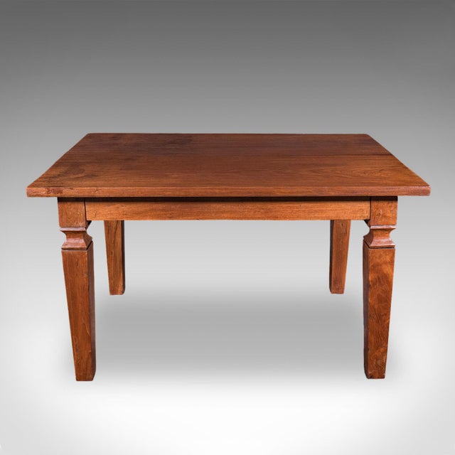 This is an antique four seater dining table. An English, solid walnut kitchen table, dating to the Edwardian period, circa...