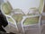 A pair of handsome Louis XVI Fauteuils open arm chairs. Both chairs feature the neoclassical oval medallion back, gently...