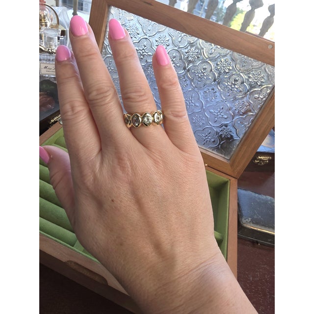 A bold yet refined statement, this vintage-inspired ring showcases the electric allure of Paraiba gemstones. Eight natural...