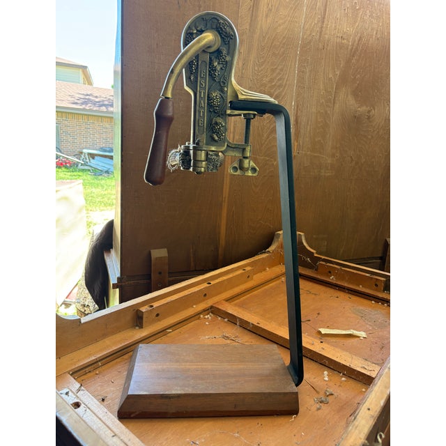 This is a Rogar Estate wine bottle opener with a hardwood stand. It is a reproduction of a 19th-century Americana...