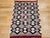 This vintage Native American Navajo area rug, woven circa the mid-1900s, features a bold and traditional diamond pattern...