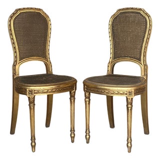 Pair of Early 20th Century French Louis XVI Style Gilted Dining Chairs with caned seats For Sale