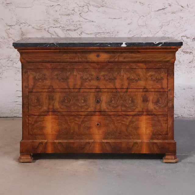 The 19th Century Louis Philippe Burled Walnut Chest with Black Marble Top is a striking example of French craftsmanship,...