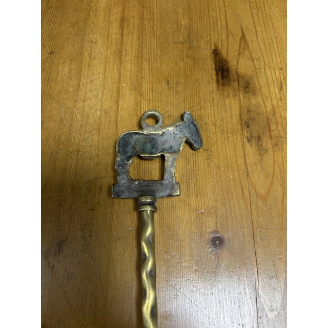 This unique vintage English brass toasting fork features a charming finial depicting a donkey alongside the word...