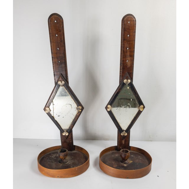 We are selling this exceptional pair of Candle sconces. These great Americana folk art pieces appear to have flamed maple...