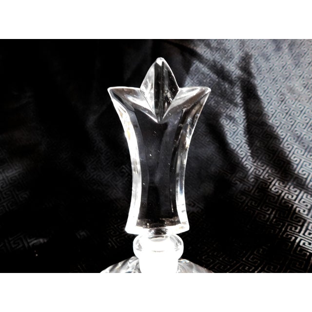 This is a lead crystal perfume bottle with an Enesco sticker as shown. It is round and is shaped or cut crystal with a...