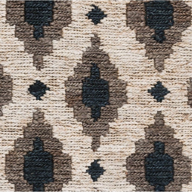 Handwoven jute rug with beautiful gray/taupe and indigo diamond patterning on contrasting ivory background. For medium...