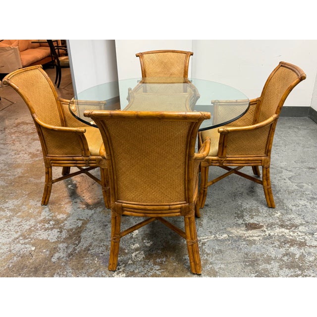Design Plus Gallery presents a Vintage Rattan + Glass Dining Set from Bassett Furniture. The set includes a round glass-...