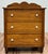 Antique pine three drawer chest featuring stunning patina, original porcelain knobs to dovetailed drawers, and scalloped...