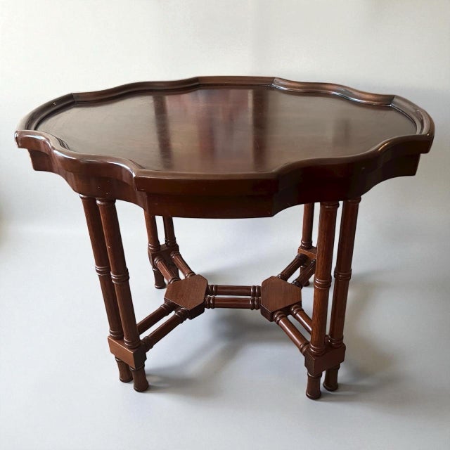 Beautiful vintage solid wood accent table featuring a scalloped top and classic faux-bamboo turned legs with stretcher...