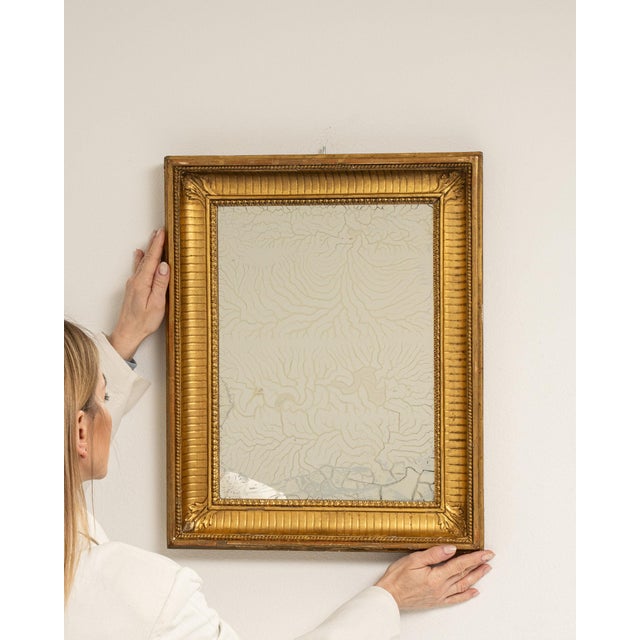 A mirror whose gold gilt textured frame, rectangular gives it real character at first glance. The piece dates to 19th...