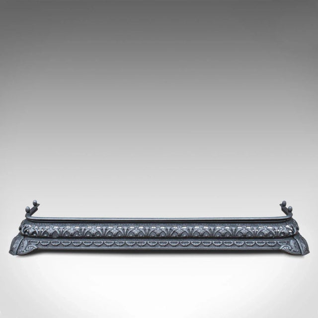 This is an antique fire kerb and companion tongs. An English, iron fireside set, dating to the Victorian period, circa...