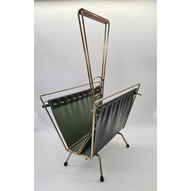 An elegant Mid-Century Modern-style magazine rack, made in West Germany in the 1970s. This model features a light,...