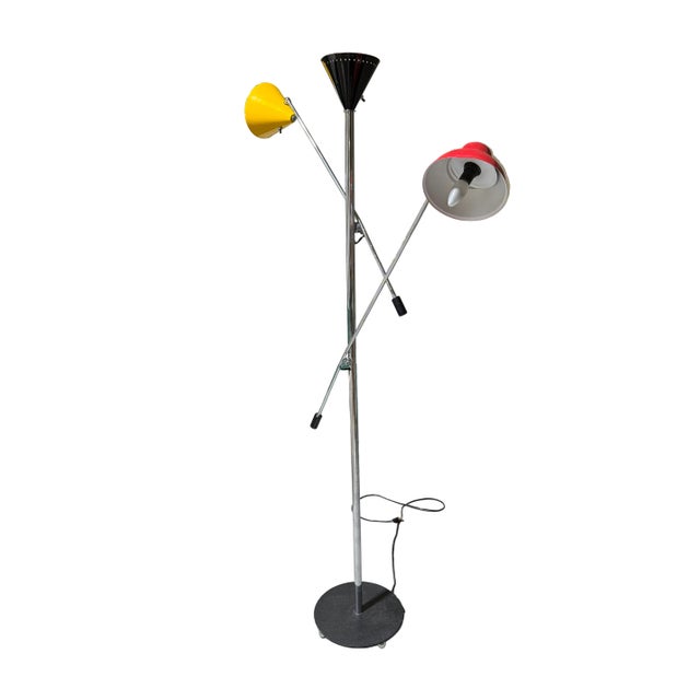 Super fun articulated three armed floor lamp with red, yellow and black lamp shades. Silver/chrome stand, arms are...