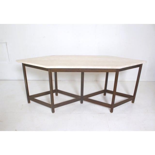 Console attributed to Jan Vlug made of Padoek with octagonal legs resting on a brass base. and a Travertine top the...