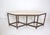 Console attributed to Jan Vlug made of Padoek with octagonal legs resting on a brass base. and a Travertine top the...