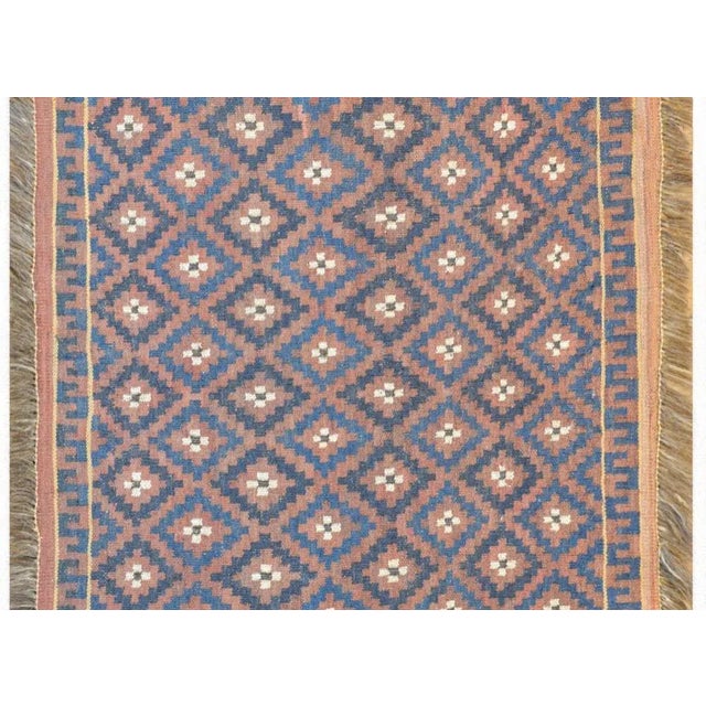 A fantastic mid-20th century Persian Baluch Soumak rug with an all-over diamond pattern containing light and dark indigo...