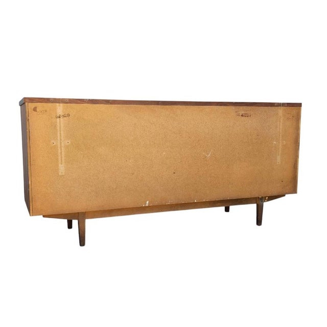 In superb condition. Mid-Century Modern Walnut Dresser by Stanley Furniture Co., c. 1960's. This solid dresser credenza...