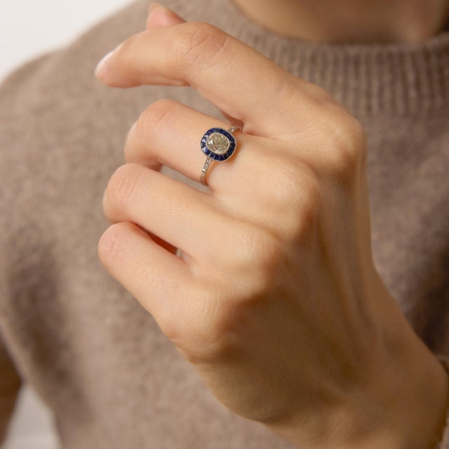 A graceful homage to the bold geometry of the 1930s, this Art Deco–inspired target engagement ring centers on a romantic...