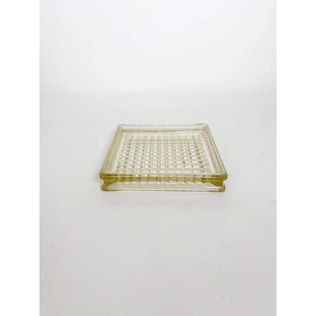 Iconic square glass ashtray inspired by the timeless design associated with Le Corbusier. Crafted in thick molded glass...