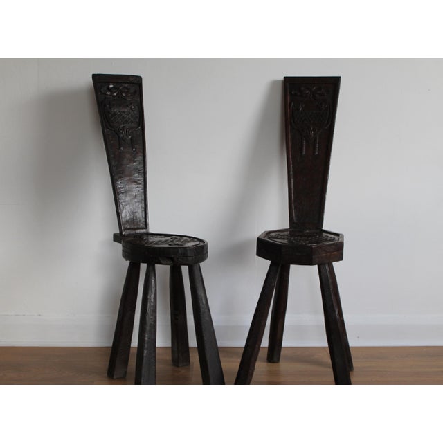 A near pair of traditional, rustic vernacular "Spinning Stools" of primitive construction being made from stout pieces of...
