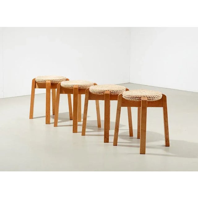 Nice set of 4 stools, most likely from Scandinavia 1990s. The stools have a solid birch structure and a rope seat. They...