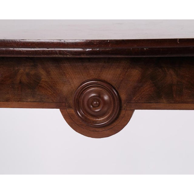 Games table made in polished mahogany from around the 1860s. The table features round carved legs and brass mounts typical...