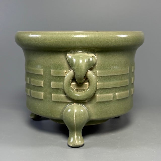 This vintage Chinese Longquan celadon incense burner rests upon three sturdy feet. It comes with decorative beast‑head...